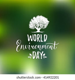 World environment day hand lettering card on blurred background. Vector tree illustration. 