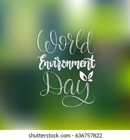 World environment day hand lettering for cards, posters etc. Vector calligraphy with leaves illustration on blurred green background.