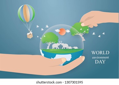 World environment and Eco earth day concept with Elephants in world on hand and Deer in the basket flying on the sky,paper craft style vector and illustration 