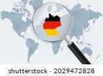 World map with a magnifying glass pointing at Germany. Map of Germany with the flag in the loop. Vector illustration.