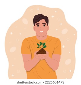 World Soil Day is held annually on December 5. The man is holding a green plant in her hands. Forest restoration, reforestation planting trees, environment day.
