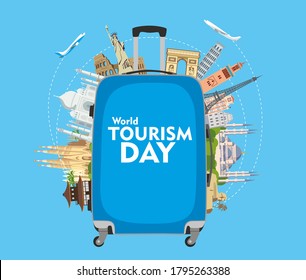 World Tourism Day. The inscription on the blue travel suitcase. Around the monuments of architecture