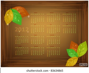 Worn brown frame with autumn leaves, water drops and the calendar grid on 2012 year