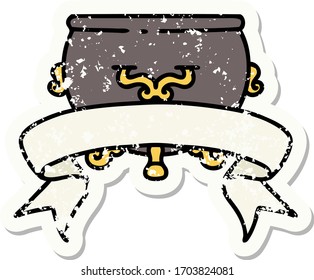 worn old sticker with banner of a cauldron