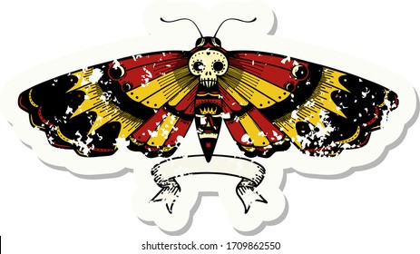 worn old sticker with banner of a deaths head moth