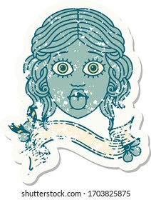 worn old sticker with banner of female face sticking out tongue