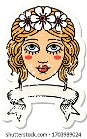worn old sticker with banner of female face with crown of flowers