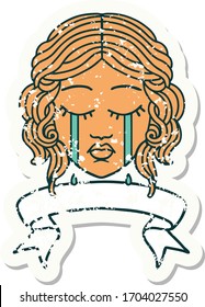 worn old sticker with banner of female face crying