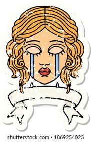 worn old sticker with banner of female face crying