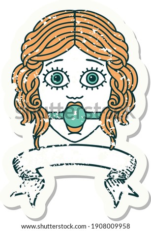 worn old sticker with banner of female face wearing a ball gag