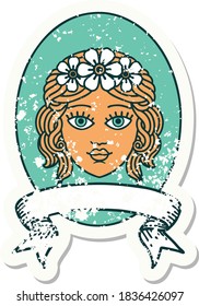 worn old sticker with banner of a maiden with crown of flowers