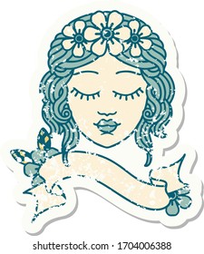 worn old sticker with banner of a maidens face