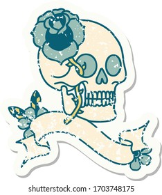 worn old sticker with banner of a skull and rose