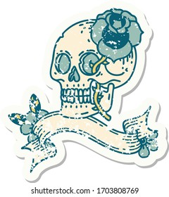 worn old sticker with banner of a skull and rose