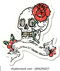 worn old sticker with banner of a skull and rose