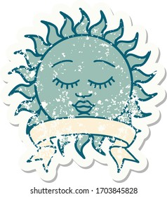 worn old sticker with banner of a sun with face