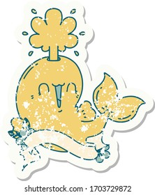 worn old sticker of a tattoo style happy squirting whale character
