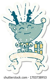 worn old sticker of a tattoo style christmas reindeer with present