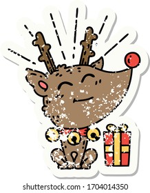 worn old sticker of a tattoo style christmas reindeer with present