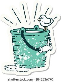 worn old sticker of a tattoo style bird perched on bucket of water