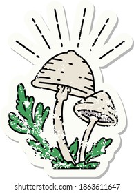 worn old sticker of a tattoo style mushrooms
