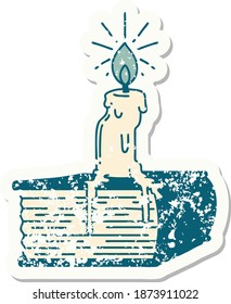worn old sticker of a tattoo style candle melting on book