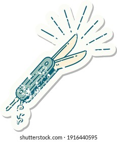 worn old sticker of a tattoo style folding knife