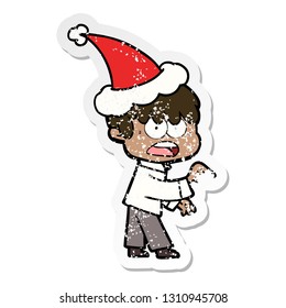 worried hand drawn distressed sticker cartoon of a boy wearing santa hat