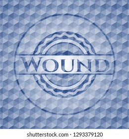 Wound blue badge with geometric background.