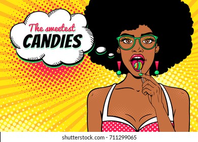 Wow female face. Sexy african american girl in glasses with afro hair, open mouth, bright lollipop in her hand and The sweetest Candies speech bubble. Vector background in pop art retro comic style. 