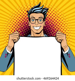 Wow pop art man. Young happy surprised man in glasses with open smile holding empty poster. Vector illustration in retro comic style. Vector pop art background.