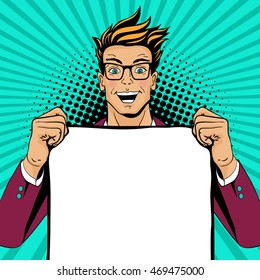 Wow pop art man. Young happy surprised man in glasses with open mouth holding empty poster for your offer. Vector colorful illustration in retro comic style. Vector pop art background.
