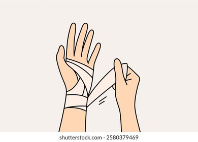 Wrapping bandage around injured arm of person who has suffered fracture or crack in bone after accident. Injured arm of fall or car accident victim needs bracing to speed up rehabilitation.