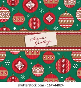 wrapping paper with red christmas baubles and ribbon with message