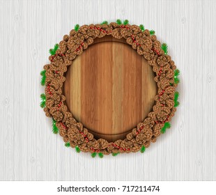 Wreath from cones with round wood border on white wood background. Winter forest christmas horizontal background with snowflakes