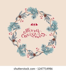 Wreath of coniferous twigs, pine cone and red berries.Merry Christmas, hand-lettering. Winter Christmas background or greeting card.