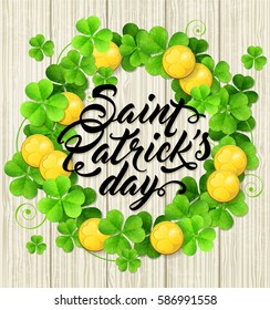 Wreath of green clover leaves and golden coins on a wooden background. Card design for St. Patrick's day.