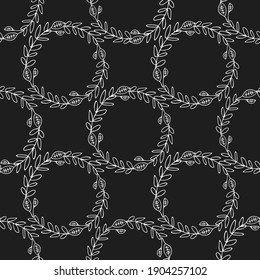 A wreath pattern with plants or grass on a black background