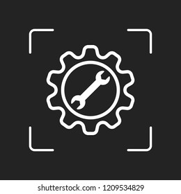 wrench in gear. White object in camera autofocus on dark background