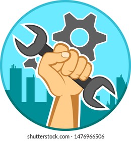 Wrench in the hand of a man on the background of the city. Labor day
