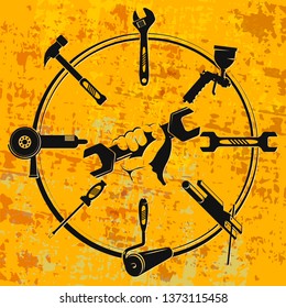 Wrench in hand and a set of tools for repair and maintenance