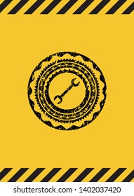 wrench icon black grunge emblem inside yellow warning sign. Vector Illustration. Detailed.