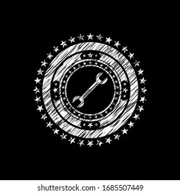 wrench icon drawn on blackboard