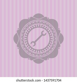 wrench icon inside badge with pink background