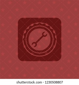 wrench icon inside badge with red background