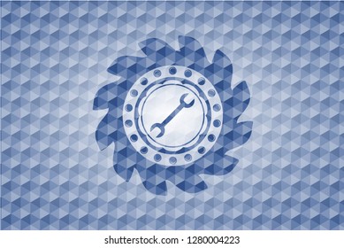 wrench icon inside blue badge with geometric pattern.