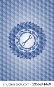 wrench icon inside blue badge with geometric pattern.