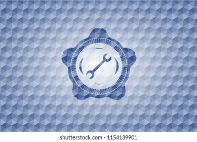 wrench icon inside blue emblem with geometric pattern background.