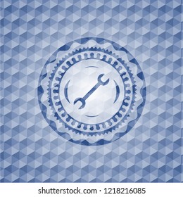 wrench icon inside blue emblem or badge with geometric pattern background.