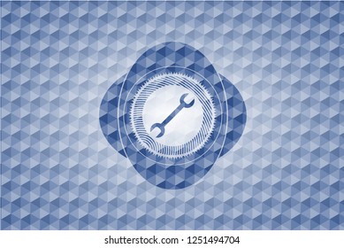wrench icon inside blue emblem or badge with geometric pattern background.